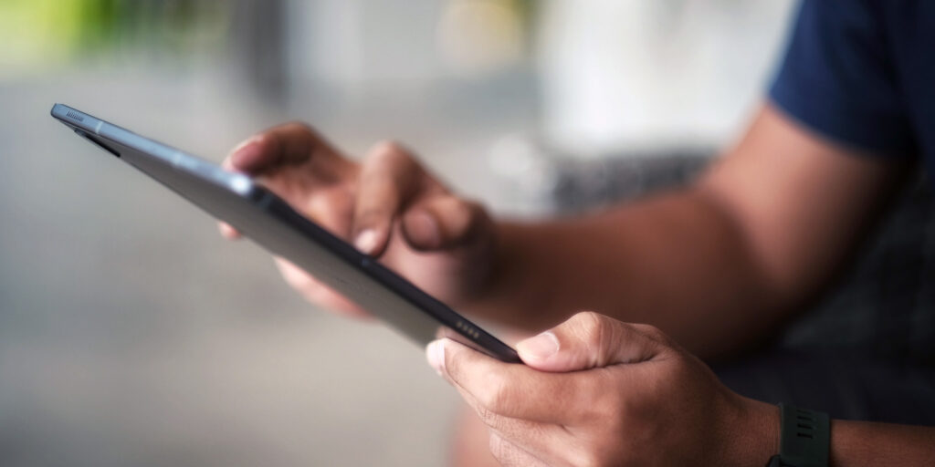 Person on an iPad, scrolling through content