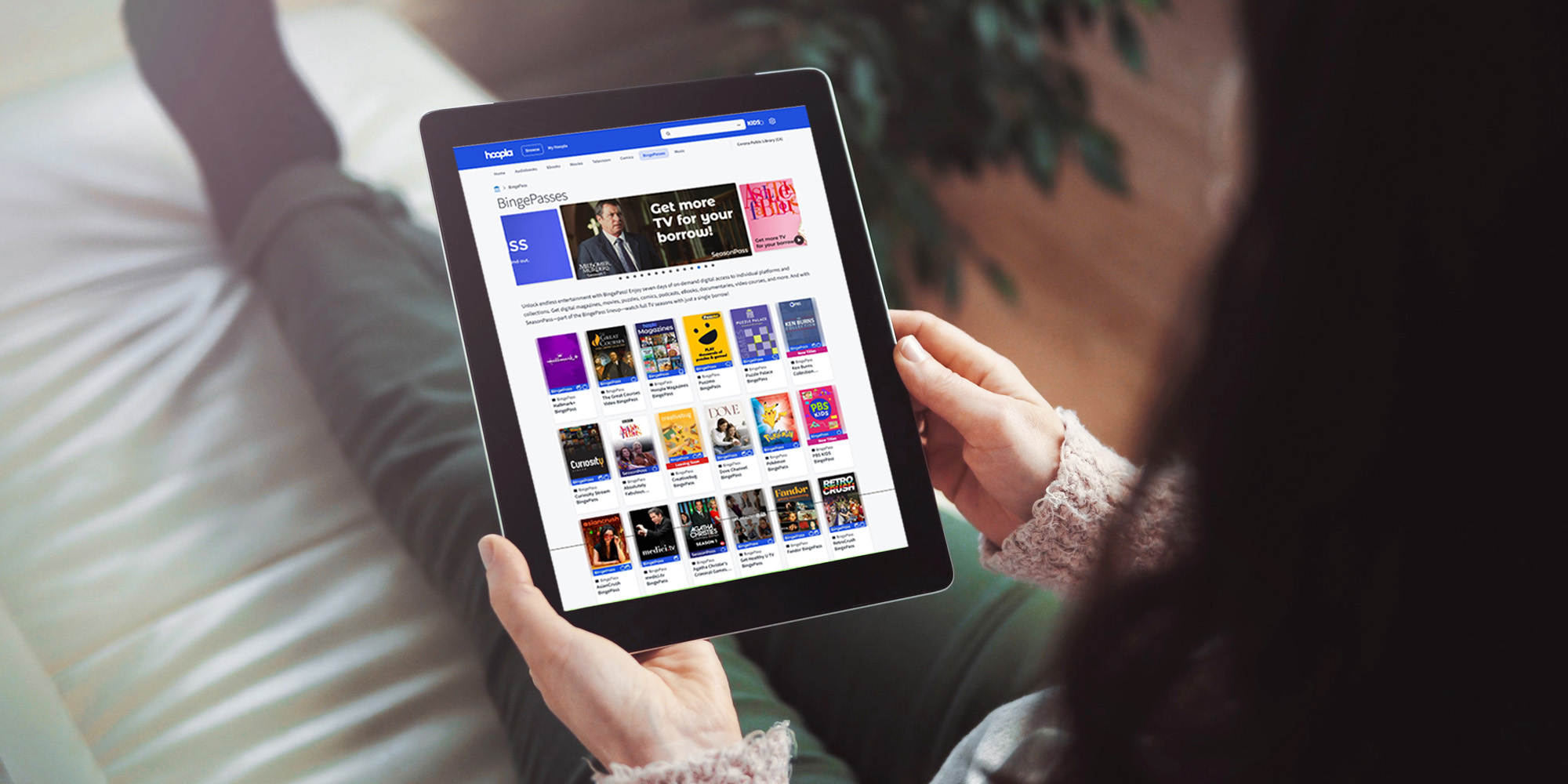 woman scrolling through hooopla's bingepass options, exploring how a library app can yield savings.