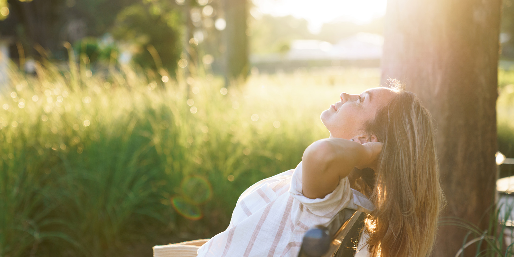 a woman relaxing outside in the sun