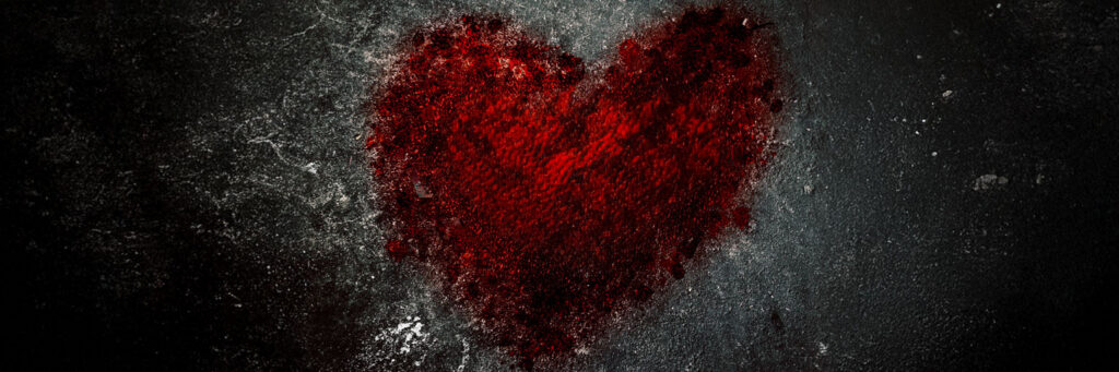 A grunge background with a heart in red as if painted with blood