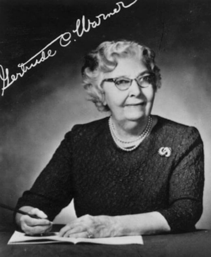 A picture of Gertrude Chandler Warner signing a book