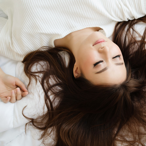 A woman looking relaxed and ready for a goodnights rest
